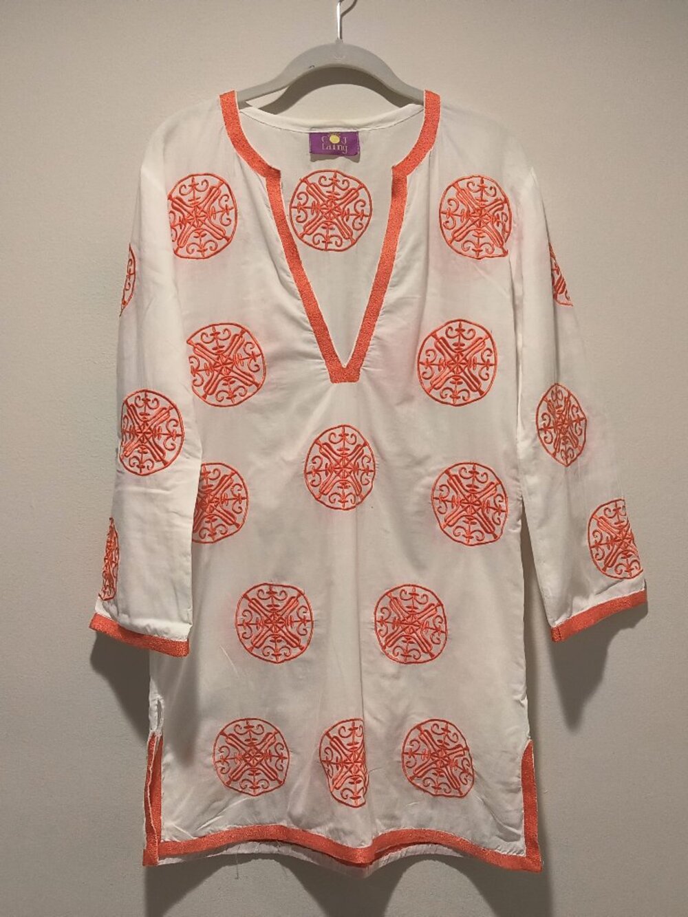 Coj Laing  orange embroidered circular motifs and a V-neckline tunic